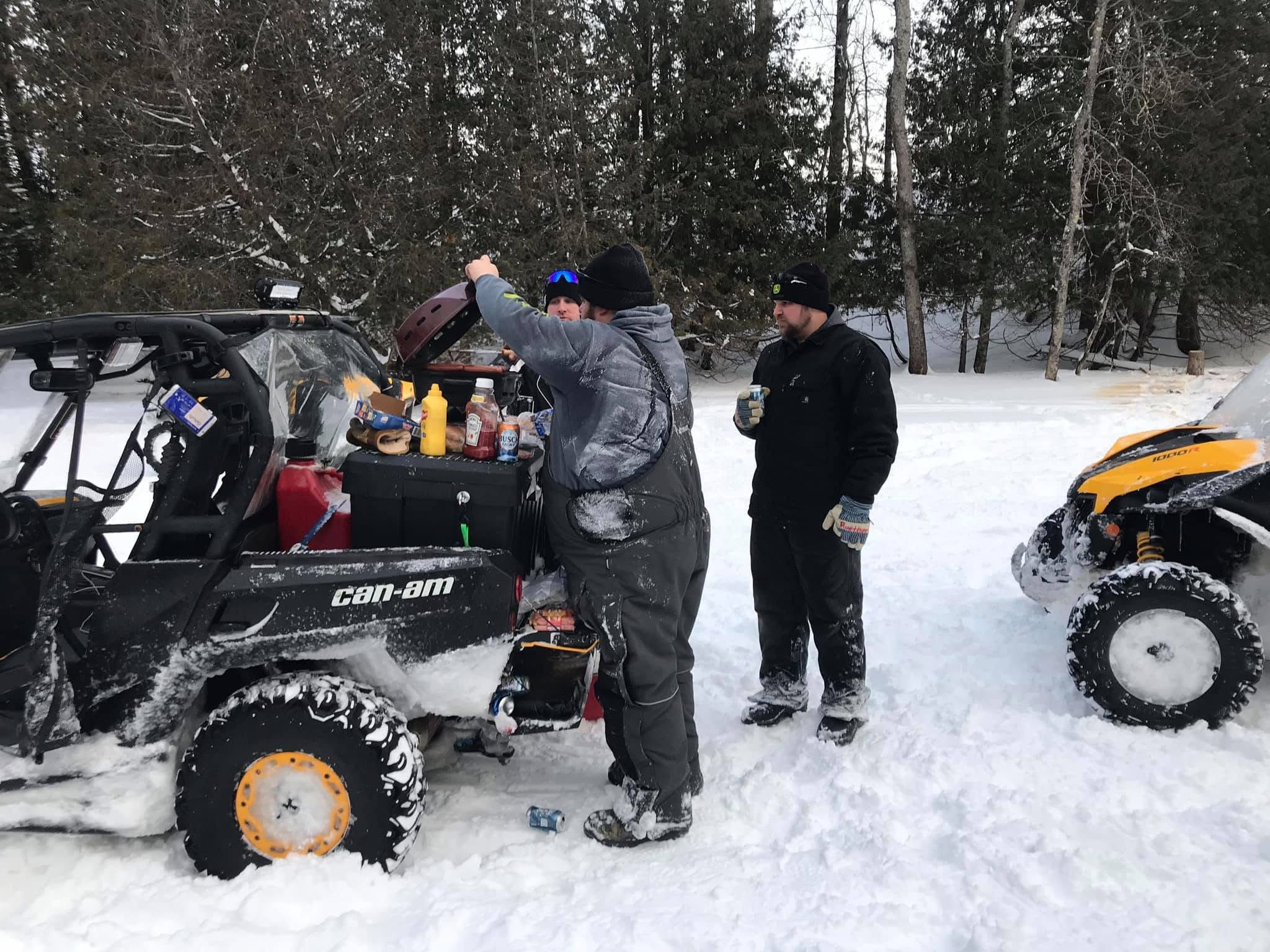 People tailgating with ATVs in winter